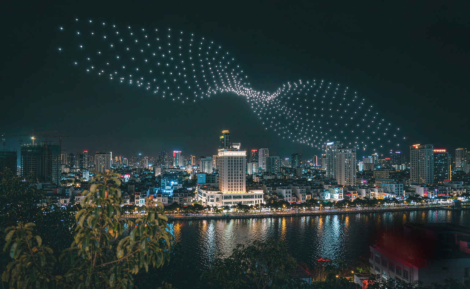 StarFlow drone light show — aerial choreography over a Vietnamese city skyline